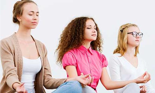 three women meditating.